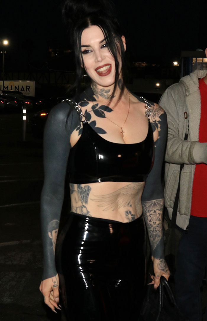 Tattoo artist in black attire with inked arms, symbolizing a shift from occult to Christianity. Tattoo artist in black attire with inked arms, symbolizing a shift from occult to Christianity.