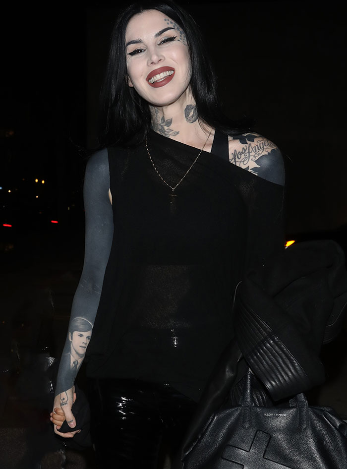Woman with blacked-out tattoos smiling, dressed in dark clothing, symbolizing a lifestyle change. Woman with blacked-out tattoos smiling, dressed in dark clothing, symbolizing a lifestyle change.