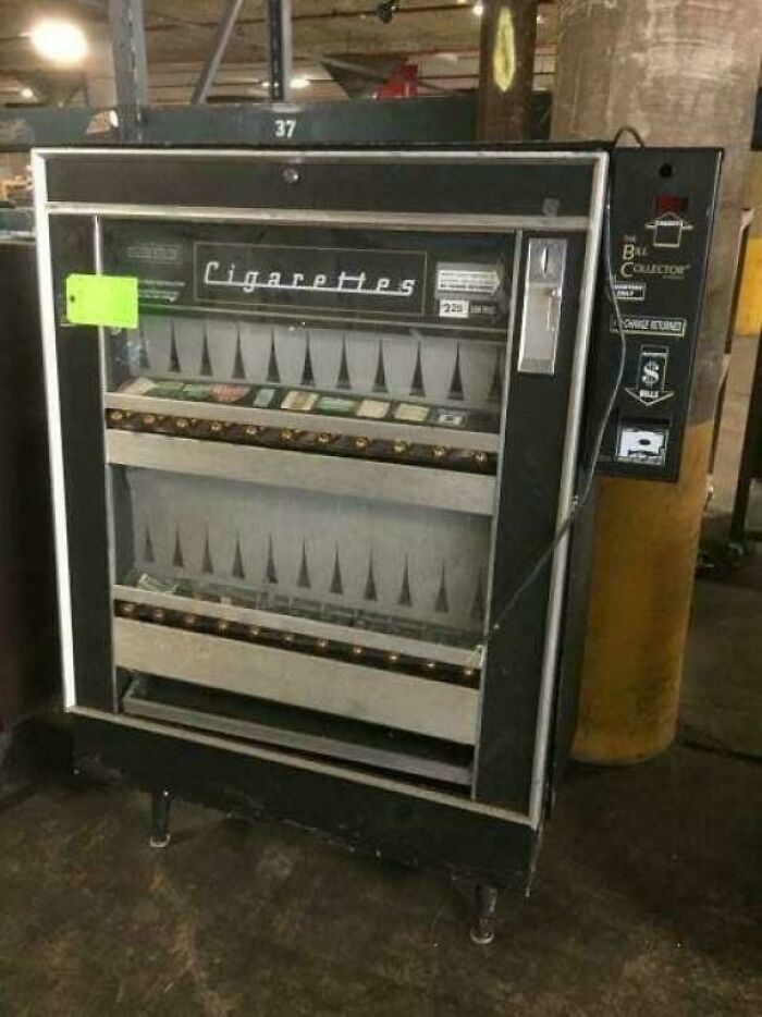 Vintage cigarette vending machine with coin slot and selector buttons, a nostalgic item for those with creaking joints memories.