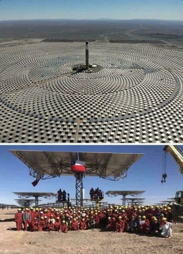 A massive array of solar panels in a desert view highlighting scale that could trigger megalophobia fears.