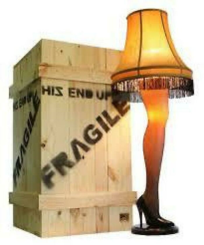 Leg lamp with fringed shade next to wooden crate marked fragile, nostalgic item for creaking joints reminder.