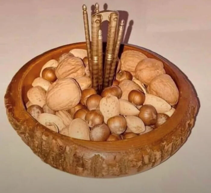 Wooden bowl filled with mixed nuts and a vintage nutcracker tool, nostalgic items that may remind you of creaking joints.