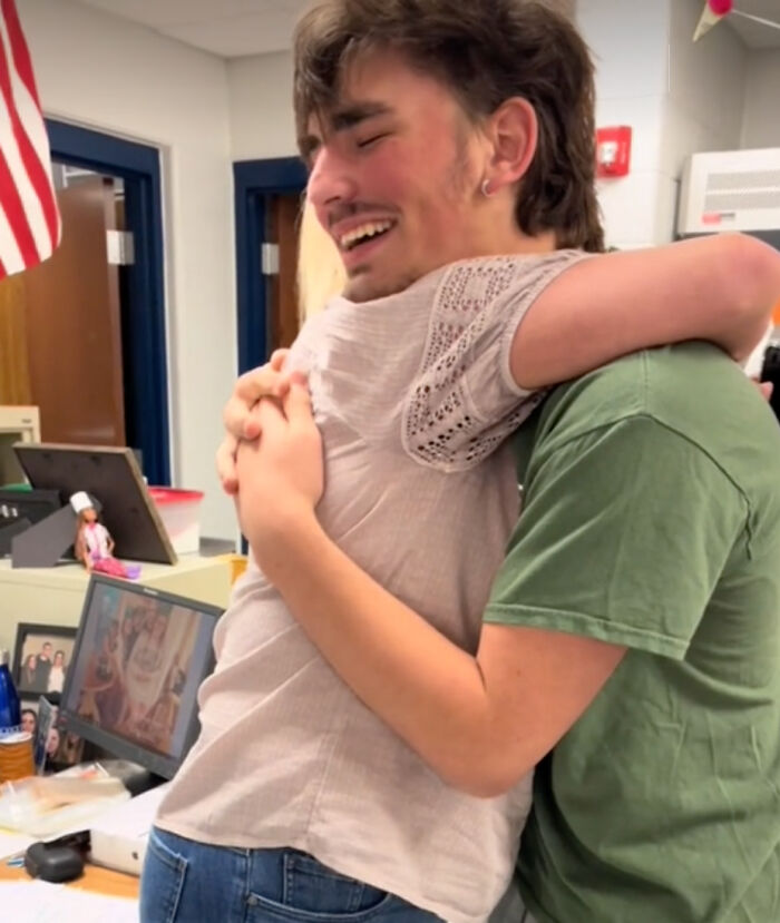 Student hugs teacher in emotional moment after tattooing her final note on his chest. Student hugs teacher in emotional moment after tattooing her final note on his chest.