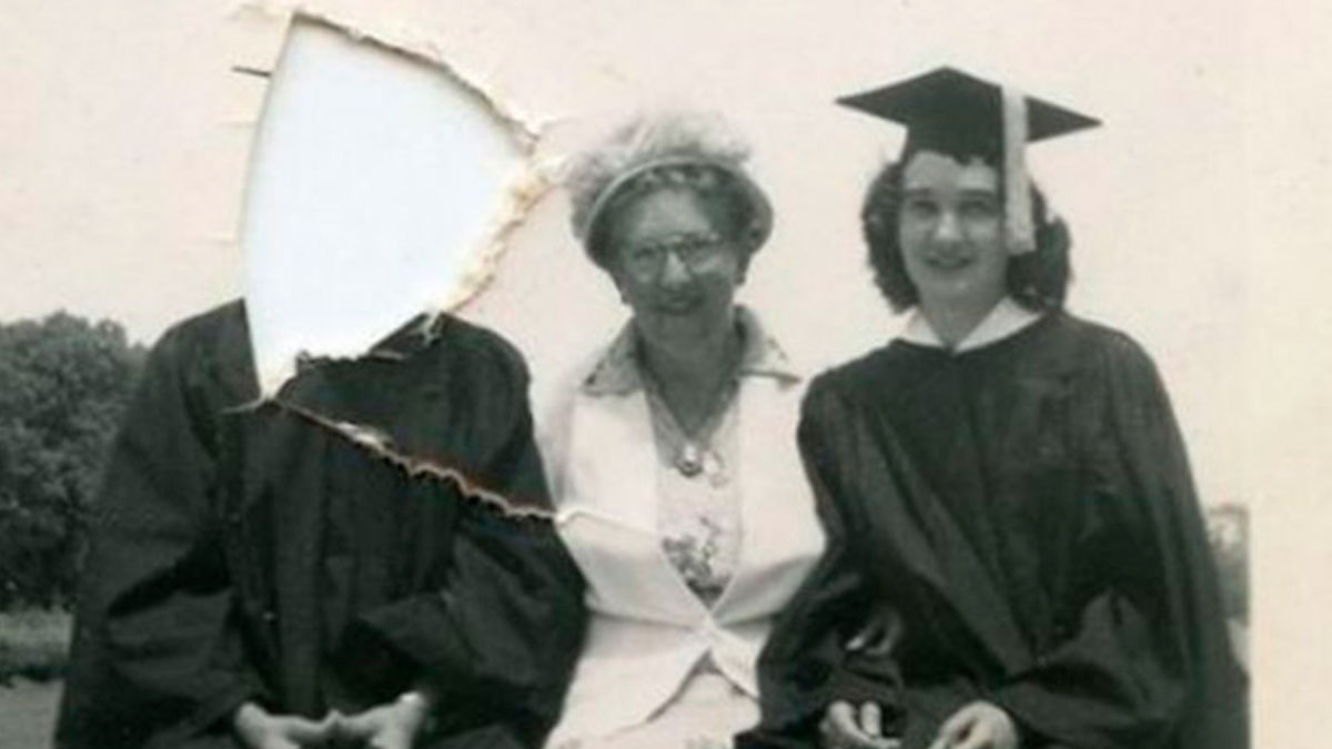 Vintage black and white photo showing two graduates and a woman, with one face torn out, funny memes for laughter.