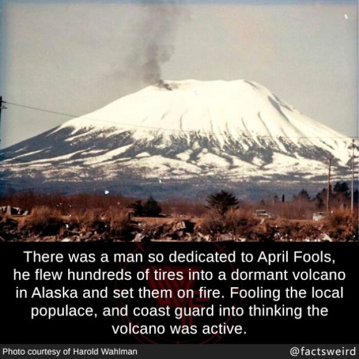 Snow-covered dormant volcano emitting smoke with fun facts about April Fools and volcanic fire prank.