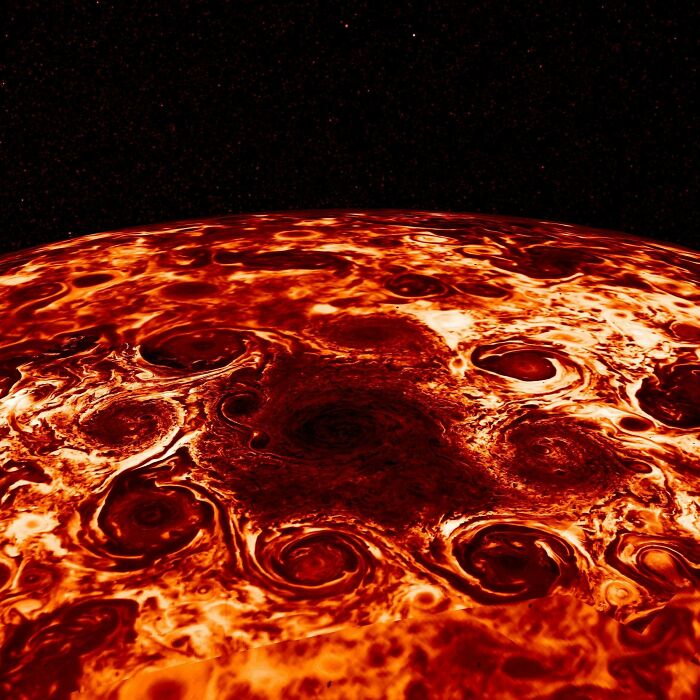 Close-up of a massive swirling storm pattern on a fiery planet surface evoking megalophobia fear of large objects.