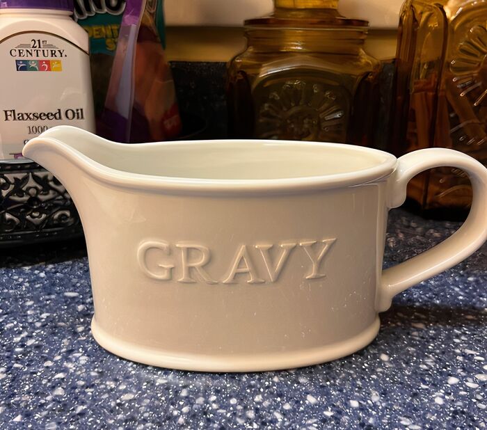White ceramic gravy boat on a kitchen counter, representing small luxuries for hosting Thanksgiving meals.