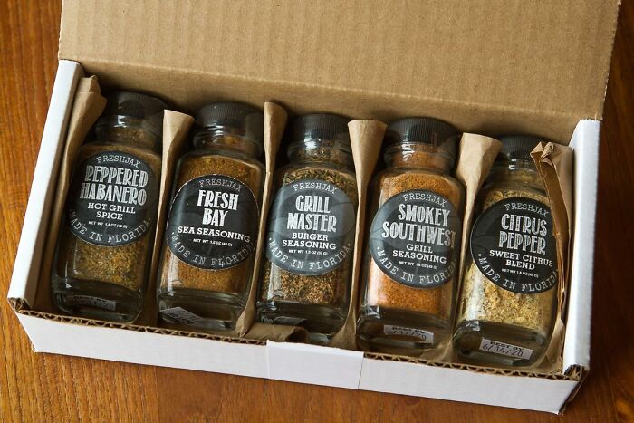 Set of gourmet grill seasonings and spices in glass jars, enhancing small luxuries for hosting Thanksgiving.