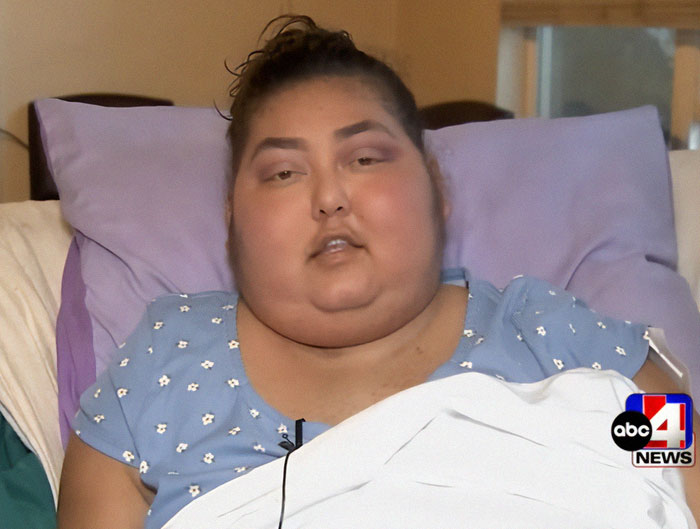 Single mom in blue top, lying on bed, part of her fundraising for funeral after terminal diagnosis. Single mom in blue top, lying on bed, part of her fundraising for funeral after terminal diagnosis.