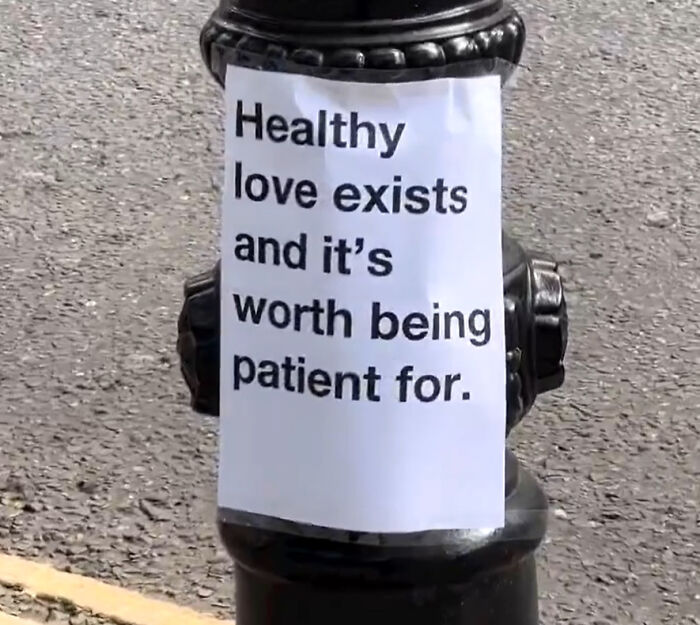 Wholesome message on London streetlamp paper sign promoting healthy love and patience to inspire people's hearts.