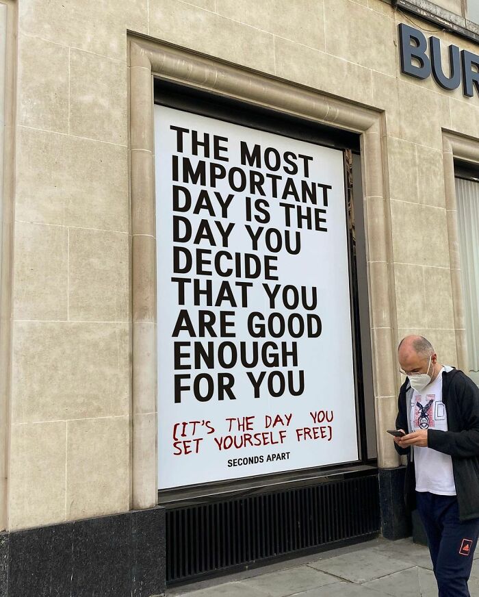 Inspirational street message in London about self-worth and being good enough, captured on a city building wall.