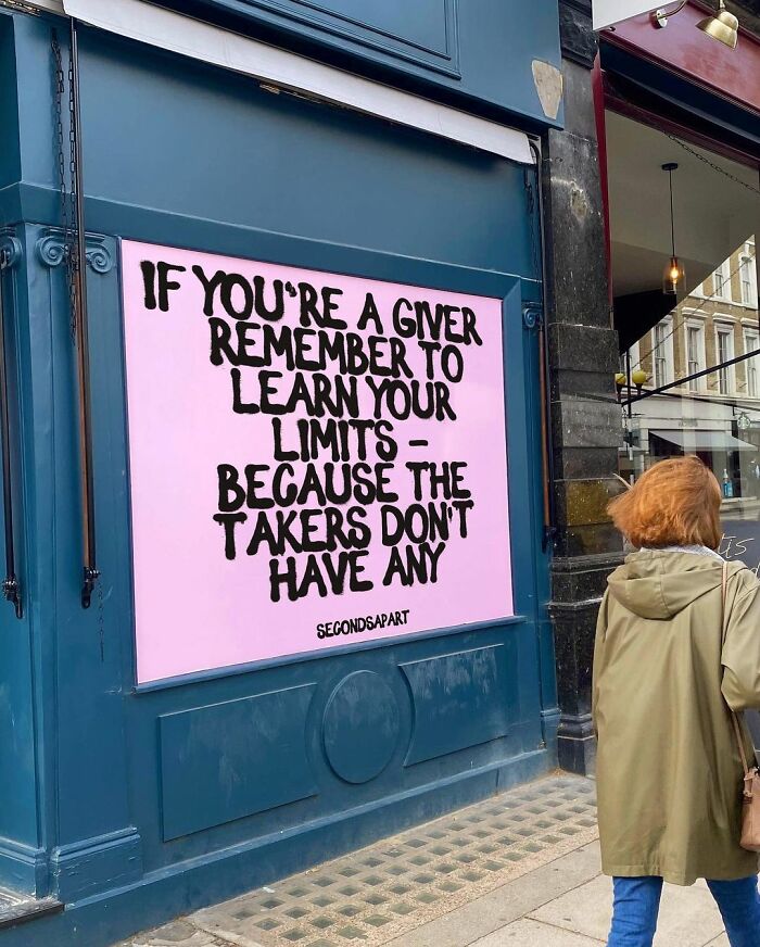 Street art in London with a wholesome message about giving limits and takers on a pastel pink background.