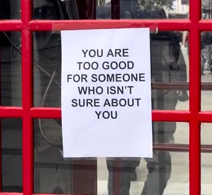 Wholesome message on a paper in a red frame in London streets encouraging self-worth and confidence for people passing by.
