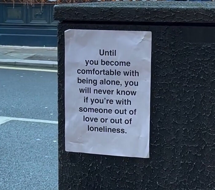 Street message on a London wall about love, loneliness, and the importance of being comfortable with being alone.
