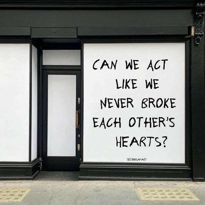 Street art in London displaying a wholesome message about healing and hearts on a storefront window.