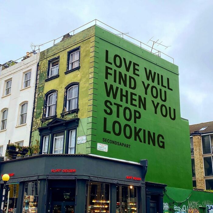 Green mural on London building displaying a wholesome message about love, captured from the streets inspiring people's hearts.