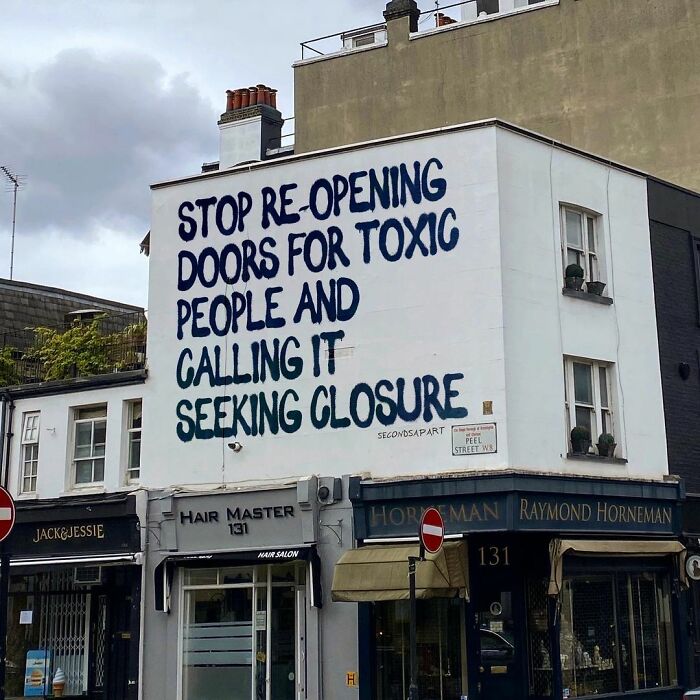Street art in London with a wholesome message about toxic people and seeking closure on a building wall.