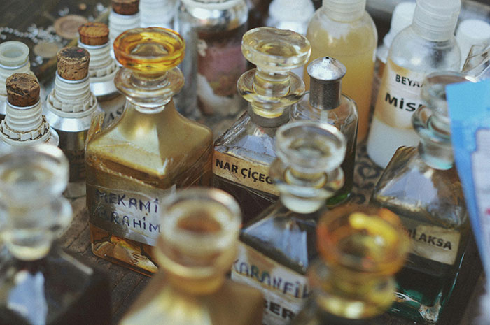 A collection of vintage perfume bottles with corked tops and labels, representing expensive perfumes stolen by the teenager. A collection of vintage perfume bottles with corked tops and labels, representing expensive perfumes stolen by the teenager.