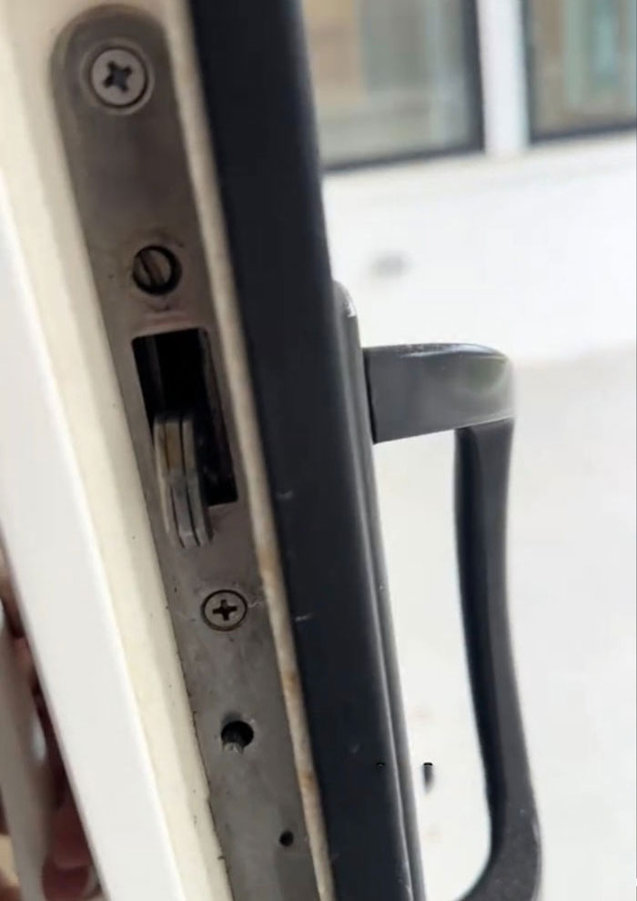 Close-up of a door lock in a two-year-old $1,600,000 home, showing poor condition. Close-up of a door lock in a two-year-old $1,600,000 home, showing poor condition.