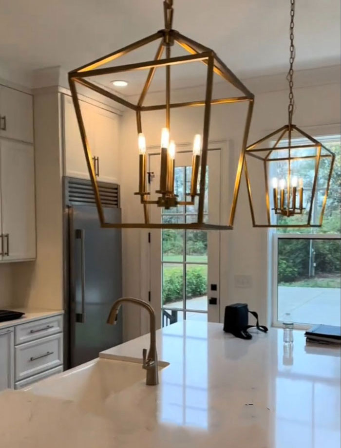Modern kitchen with marble island in a $1,600,000 home, showcasing elegant pendant lights and stainless steel appliances. Modern kitchen with marble island in a $1,600,000 home, showcasing elegant pendant lights and stainless steel appliances.