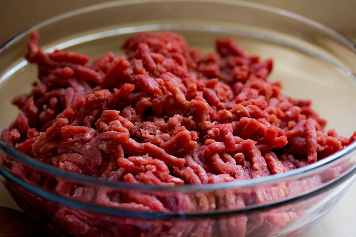 Bowl of raw ground meat, related to vegetarian mom concerned about family feeding baby meat. Bowl of raw ground meat, related to vegetarian mom concerned about family feeding baby meat.