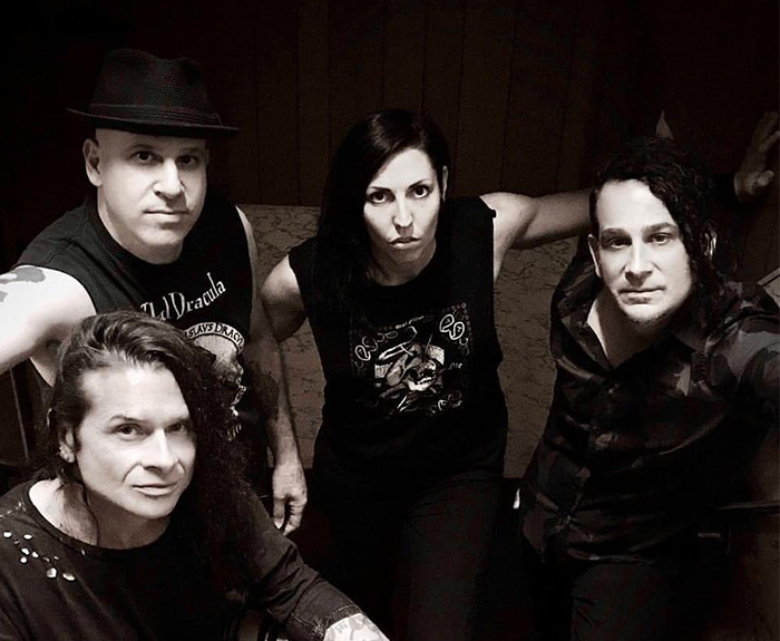 Rock singer with bandmates in a black and white photo, wearing casual outfits. Rock singer with bandmates in a black and white photo, wearing casual outfits.