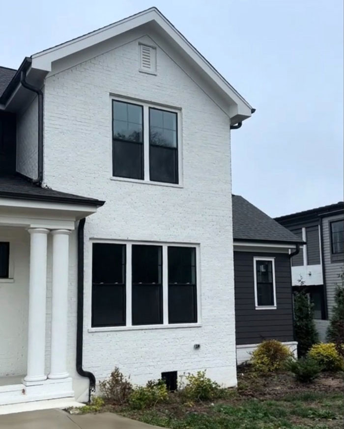 $1,600,000 home exterior with white brick, two-story facade, columns, and windows, built 2 years ago. $1,600,000 home exterior with white brick, two-story facade, columns, and windows, built 2 years ago.