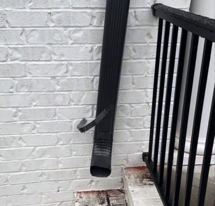 Downspout duct-taped to a brick wall on a $1,600,000 home built 2 years ago, illustrating poor construction condition. Downspout duct-taped to a brick wall on a $1,600,000 home built 2 years ago, illustrating poor construction condition.