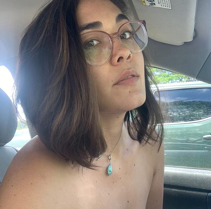 Hannah Kobayashi sitting in a car, wearing glasses and a turquoise necklace; related to missing person and airport investigations. Hannah Kobayashi sitting in a car, wearing glasses and a turquoise necklace; related to missing person and airport investigations.