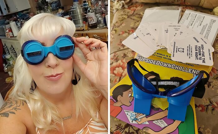 Woman wearing blue compact game goggles next to straightforward game cards and box on floral surface.