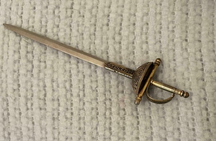 Intricately designed letter opener shaped like a sword, showcasing excellent craftsmanship.