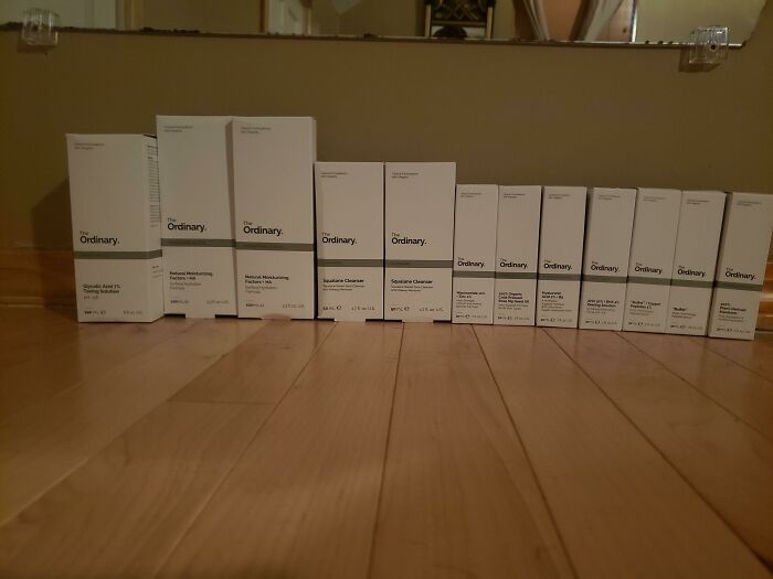 Skincare products from The Ordinary lined up on a wooden floor, highlighting an amazing collection for mothers-in-law.