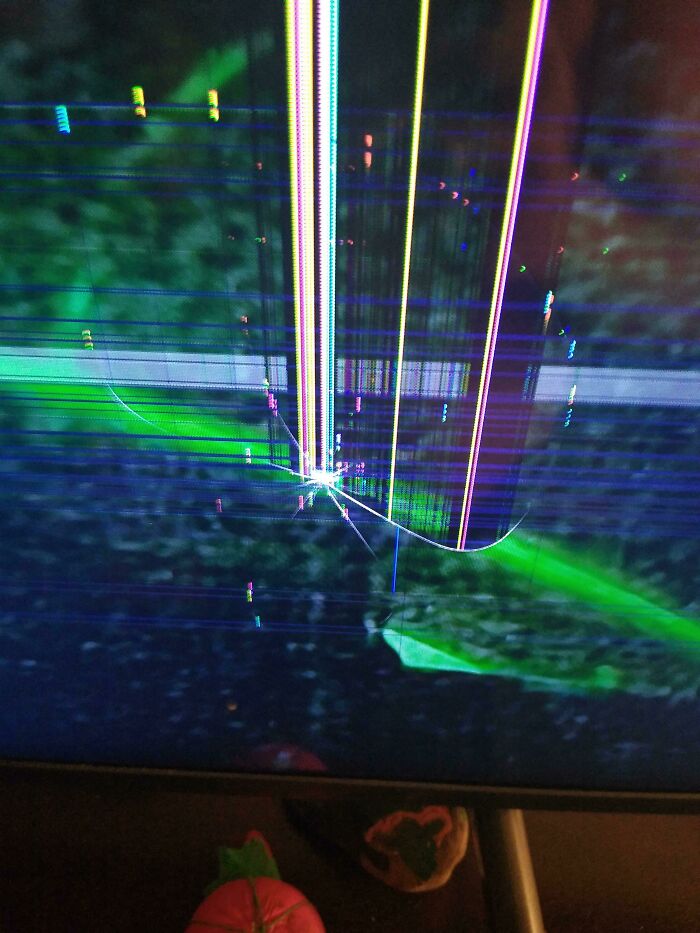 A damaged TV screen displaying colorful vertical lines, suggesting tech frustration from infuriating family members.