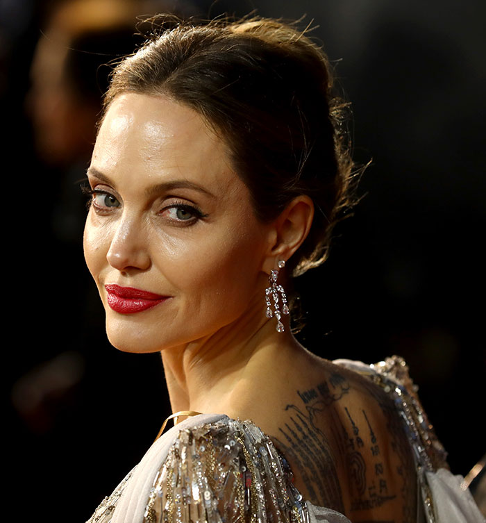 Angelina Jolie with a glamorous look, sparking Vogue Mexico cover backlash, wearing sparkling earrings and a sequin dress. Angelina Jolie with a glamorous look, sparking Vogue Mexico cover backlash, wearing sparkling earrings and a sequin dress.