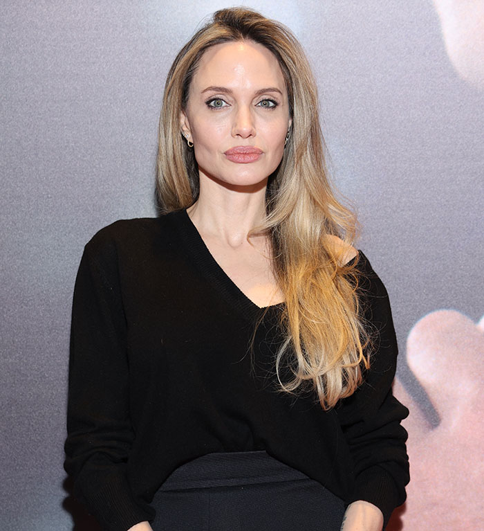 Angelina Jolie posing in a black outfit. Angelina Jolie posing in a black outfit.