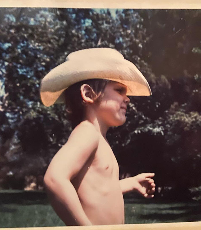 Child wearing a cowboy hat outdoors, with trees in the background, referencing mountain lions and cougars. Child wearing a cowboy hat outdoors, with trees in the background, referencing mountain lions and cougars.