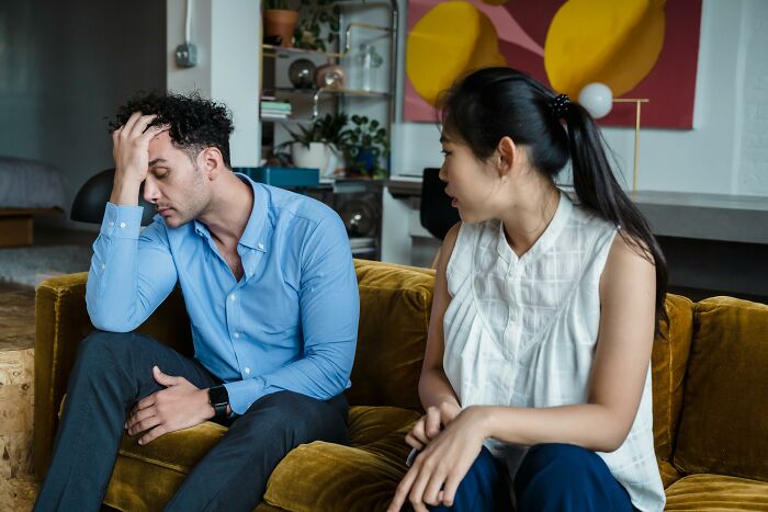 Woman annoyed at partner on couch, deciding to leave due to lack of commitment. Woman annoyed at partner on couch, deciding to leave due to lack of commitment.