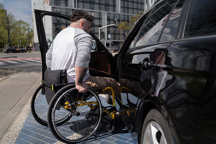 Man in wheelchair confronting a car parked in a handicapped spot. Man in wheelchair confronting a car parked in a handicapped spot.