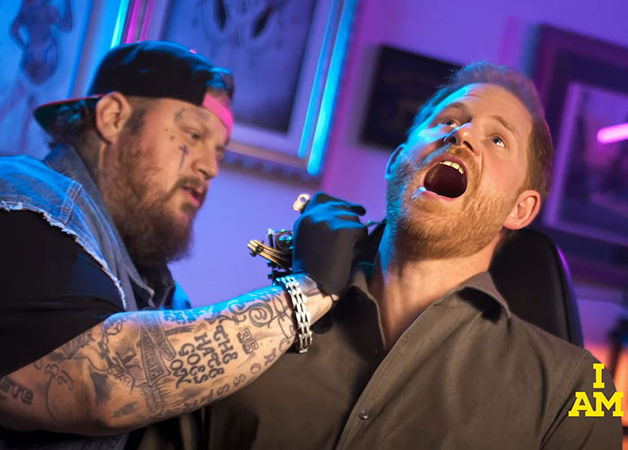 Tattoo artist giving a neck tattoo in a vibrant studio setting. Tattoo artist giving a neck tattoo in a vibrant studio setting.