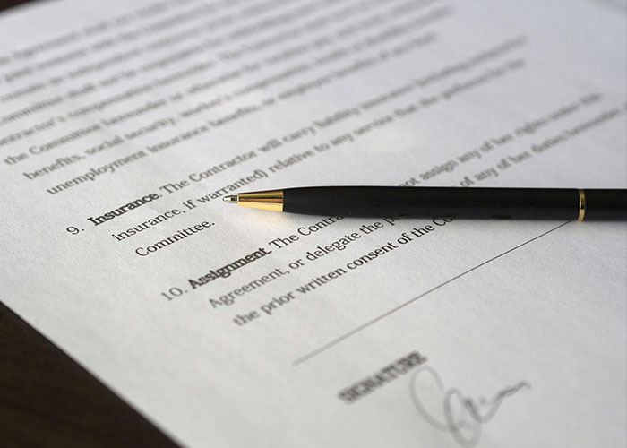 Document focused on financial security with a pen lying on top, highlighting personal finance protection. Document focused on financial security with a pen lying on top, highlighting personal finance protection.