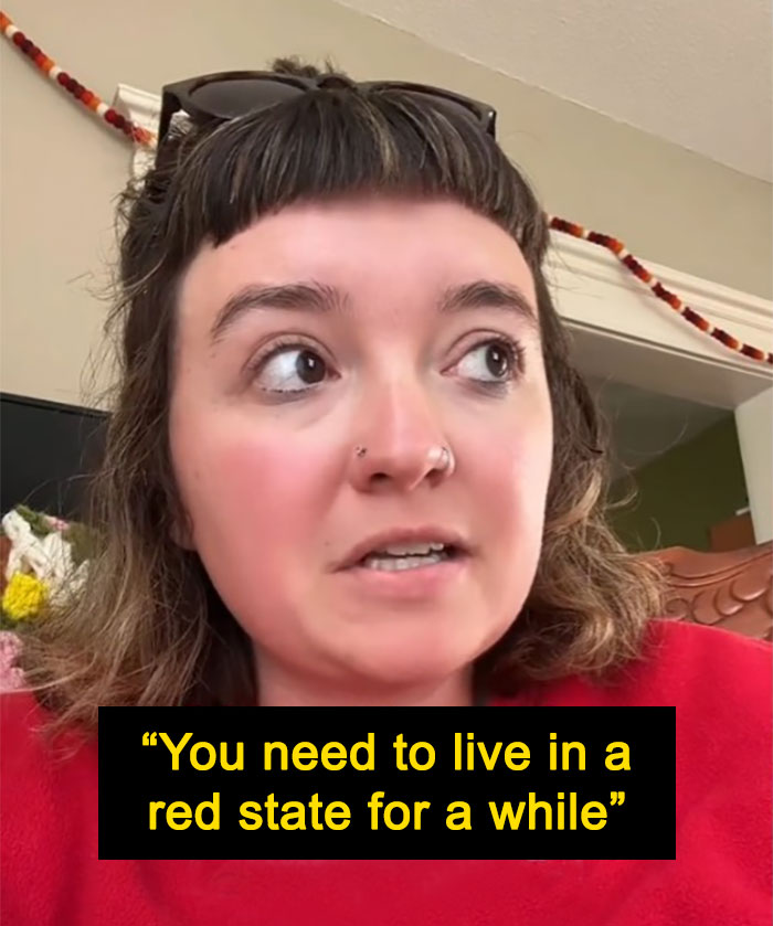 Woman shares thoughts on moving to a blue state, wearing a red shirt indoors, with a quote in bold text below. Woman shares thoughts on moving to a blue state, wearing a red shirt indoors, with a quote in bold text below.