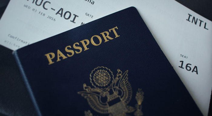 Passport and boarding pass on table, signifying man's thoughtful surprise plan. Passport and boarding pass on table, signifying man's thoughtful surprise plan.