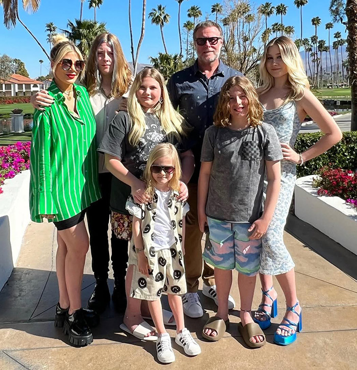 Tori Spelling with family outdoors. Tori Spelling with family outdoors.