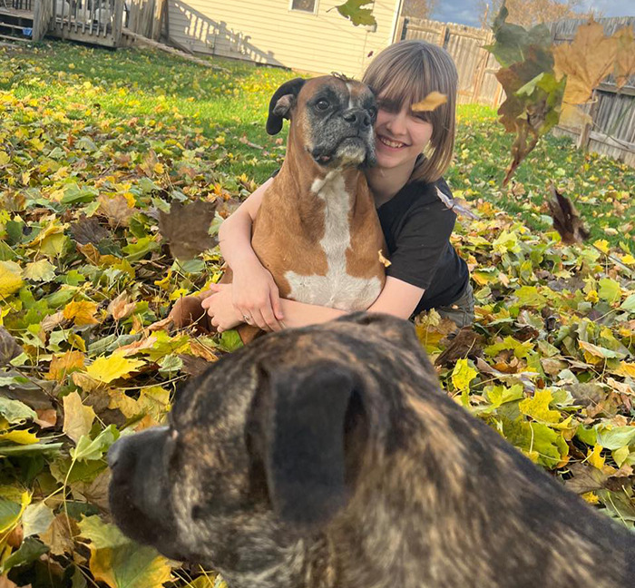 Natalie Rupnow hugging a dog in a yard with autumn leaves, related to Wisconsin school tragedy secrets. Natalie Rupnow hugging a dog in a yard with autumn leaves, related to Wisconsin school tragedy secrets.