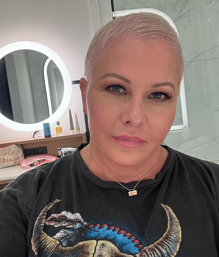 Nicole Eggert with short hair in a serene setting. Nicole Eggert with short hair in a serene setting.