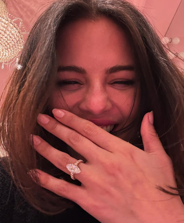 Selena Gomez smiling with hand over mouth, showing a large diamond engagement ring. Selena Gomez smiling with hand over mouth, showing a large diamond engagement ring.