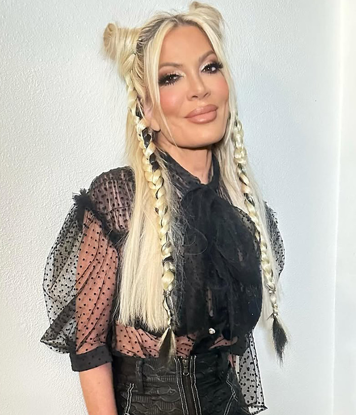 Tori Spelling with braided hair and sheer black top stands against a white background, related to "awful parenting" article. Tori Spelling with braided hair and sheer black top stands against a white background, related to "awful parenting" article.