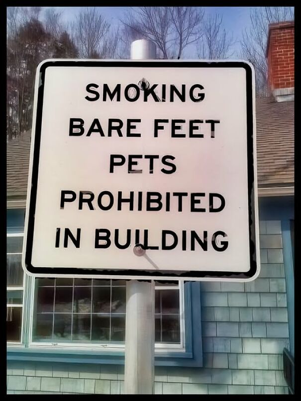 Weird sign stating smoking, bare feet, and pets are prohibited in the building.