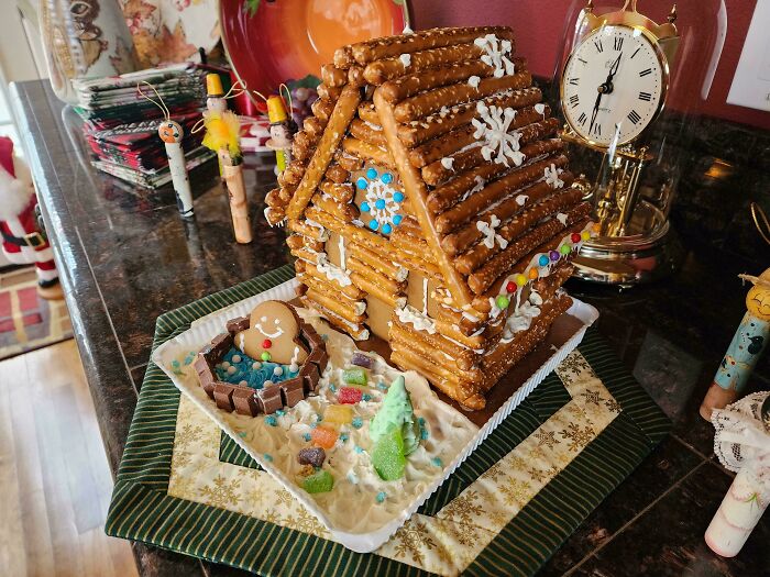 Gingerbread house with pretzel walls and candy decorations, showcasing amazing creativity often found in mother-in-law gifts.