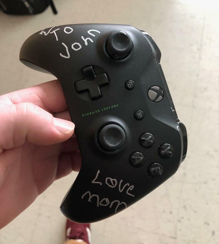 Game controller with loving message from mother, "To John, Love Mom," showcasing amazing mothers-in-law.